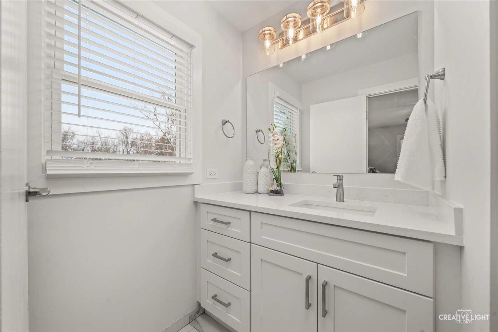 704 Plainfield Road Downers Grove, IL 60516 - Photo 16 of 36 a bathroom with a sink vanity granite and a mirror