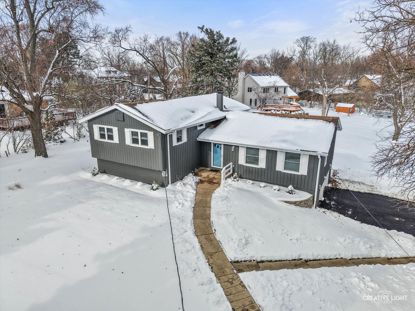 704 Plainfield Road Downers Grove, IL 60516 - Photo 2 of 36 a view of a house with a yard covered in snow