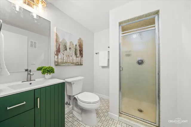 a bathroom with a toilet a sink and a shower