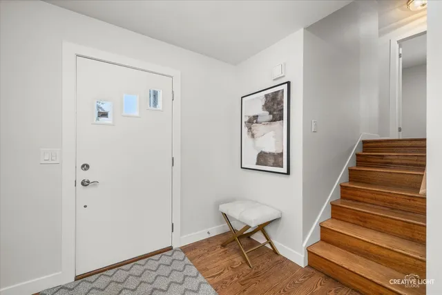 a view of a hallway with stairs and a workspace