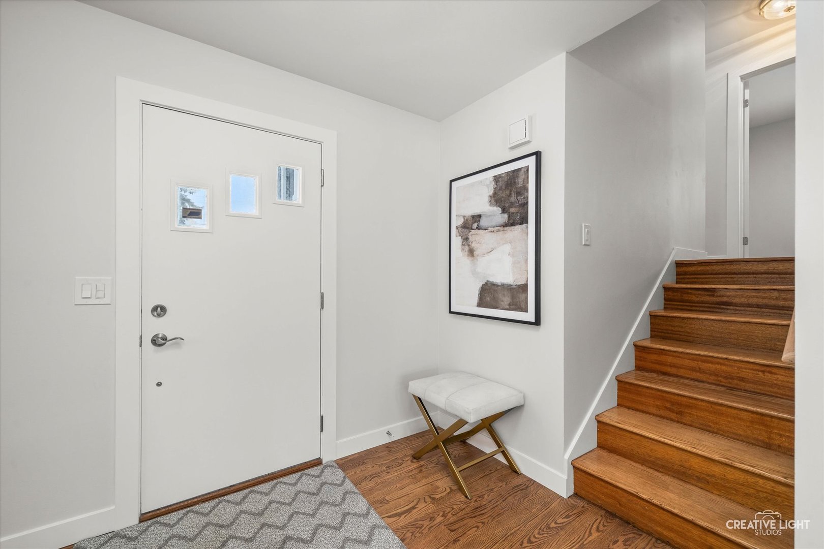 704 Plainfield Road Downers Grove, IL 60516 - Photo 3 of 36 a view of a hallway with stairs and a workspace