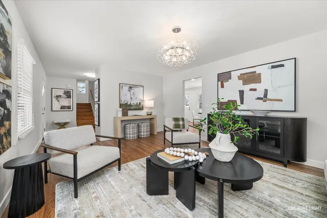a living room with furniture and a chandelier