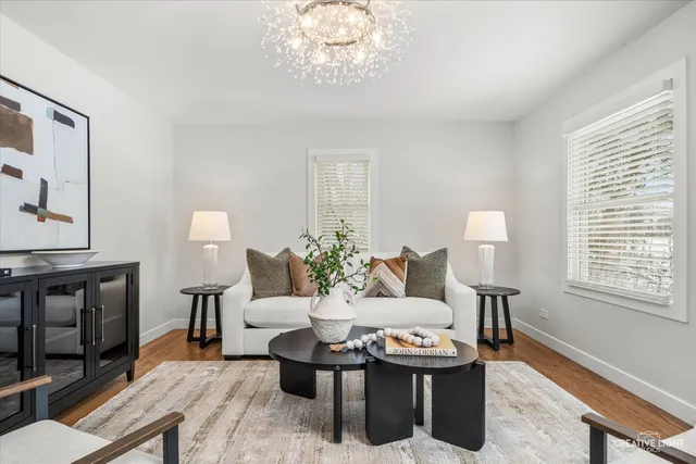 a living room with furniture a window and a table