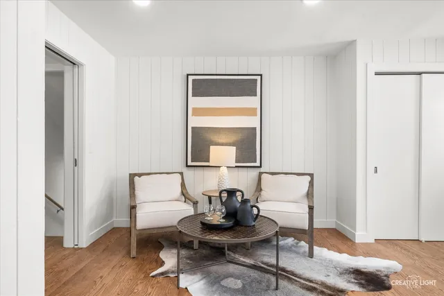 a living room with a couch and a table with wooden floor