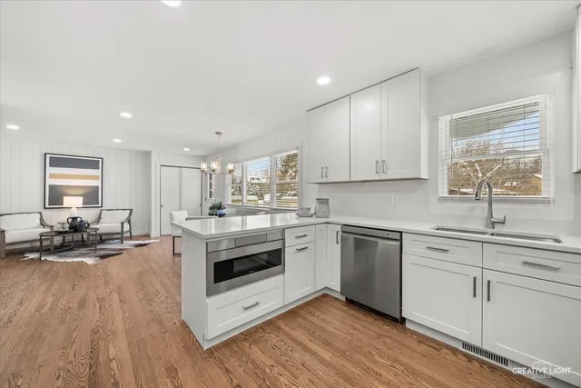 a kitchen with stainless steel appliances granite countertop a stove and white cabinets