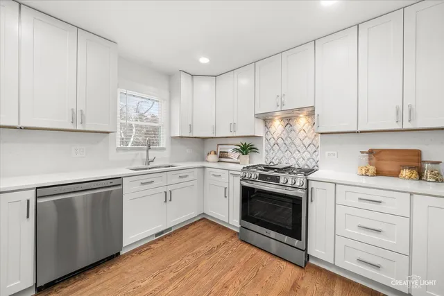 a kitchen with granite countertop white cabinets and white appliances