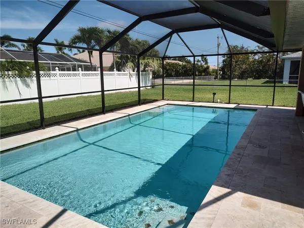 a view of a patio with table and chairs and potted plants