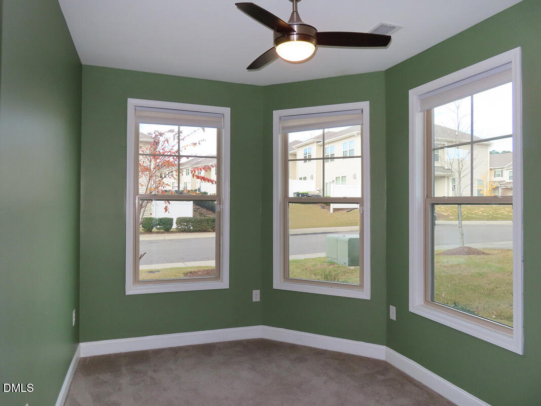 1217 Compass Drive Durham, NC 27713 - Photo 12 of 29 a view of an empty room with a window and wooden floor