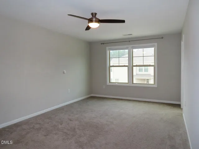 a view of room with a ceiling fan and window