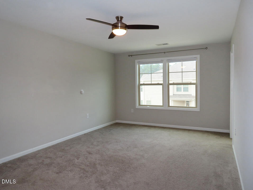 1217 Compass Drive Durham, NC 27713 - Photo 15 of 29 a view of room with a ceiling fan and window