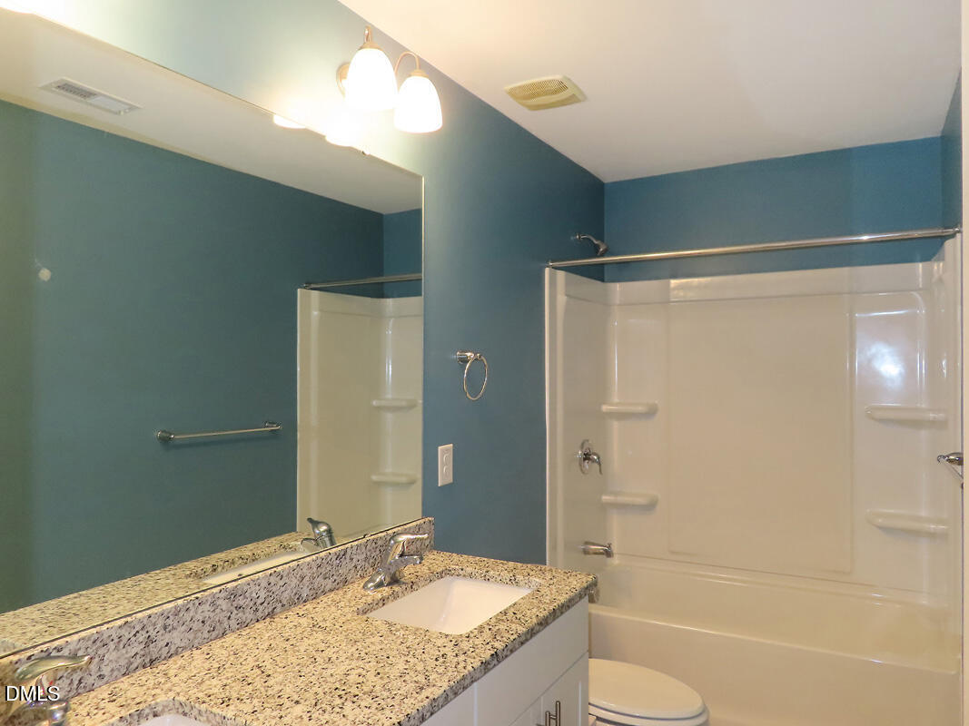 1217 Compass Drive Durham, NC 27713 - Photo 19 of 29 a bathroom with a granite countertop sink toilet and shower