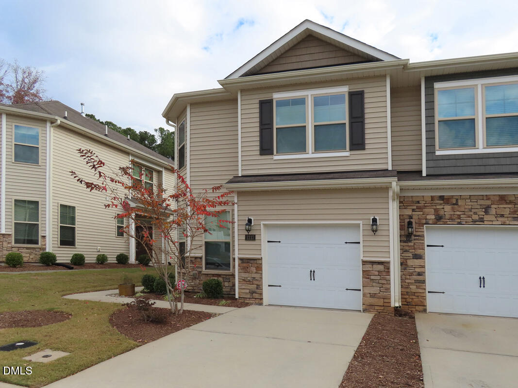 1217 Compass Drive Durham, NC 27713 - Photo 27 of 29 a front view of a house with a yard