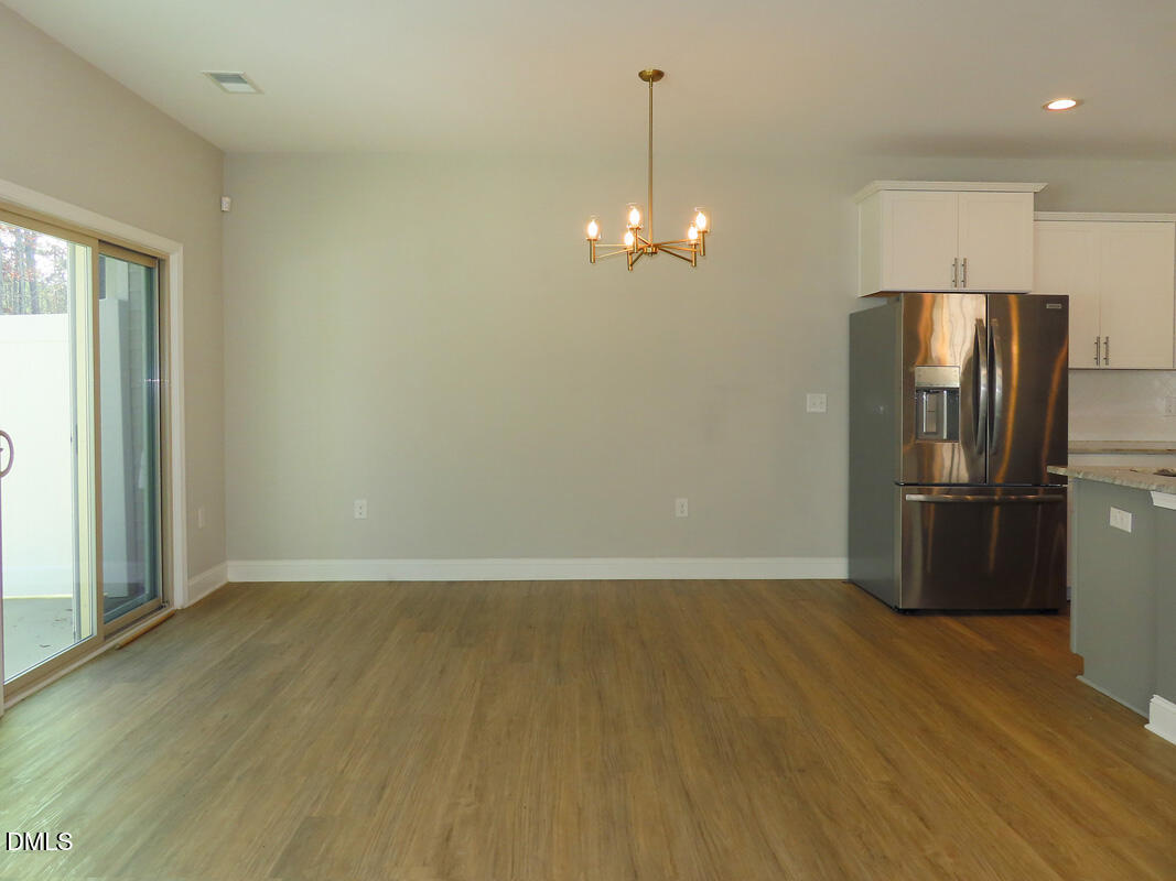 1217 Compass Drive Durham, NC 27713 - Photo 8 of 29 a view of a kitchen with a sink and refrigerator