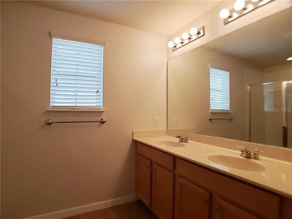 a bathroom with a double vanity sink and a mirror