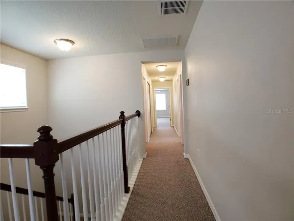 a view of a hallway with a window