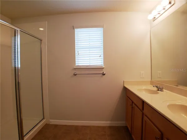 a bathroom with a sink a mirror and a shower
