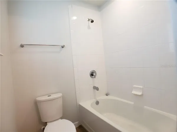 a bathroom with a toilet and a bathtub
