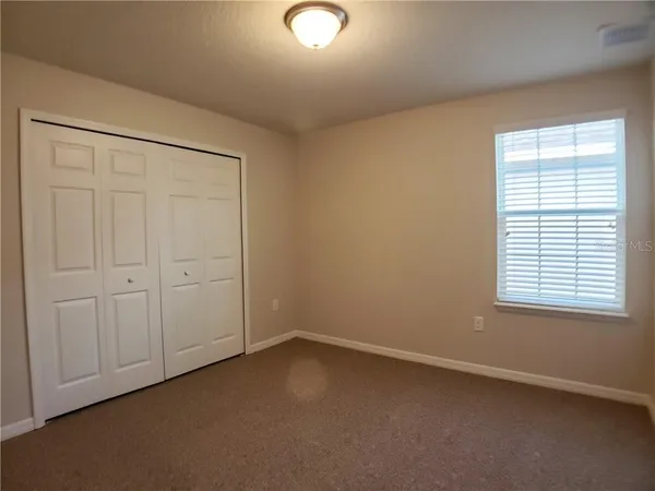 an empty room with a empty space and windows