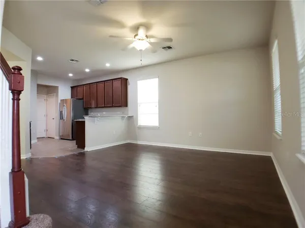 a view of a kitchen with a sink and a refrigerator