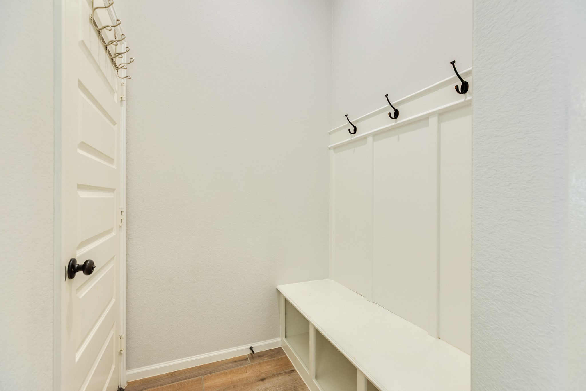 10115 Stride Court Rosharon, TX 77583 - Photo 25 of 40 Mudroom area with built-in storage and convenient hooks for backpacks, providing a spacious and organized entry point directly from the garage.