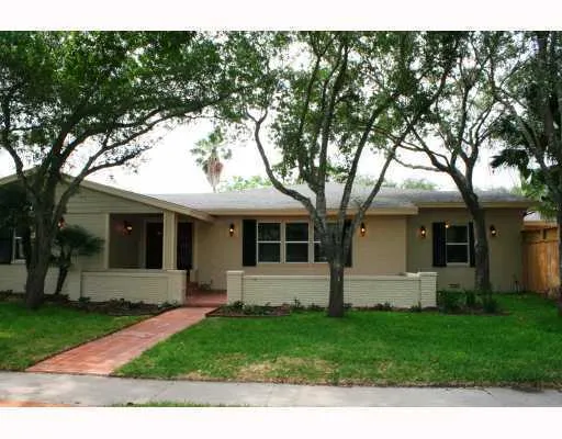 a front view of house with a garden