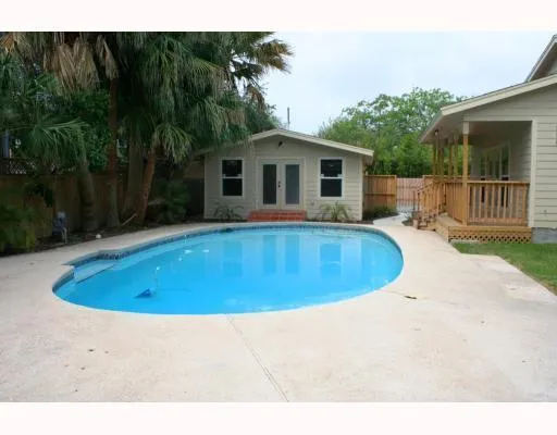 a swimming pool with outdoor seating and yard