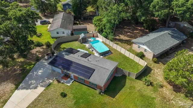 a view of backyard with deck and a garden