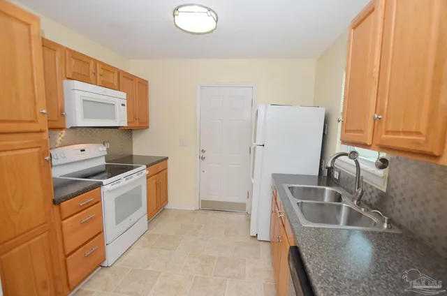 a white refrigerator freezer sitting in a kitchen