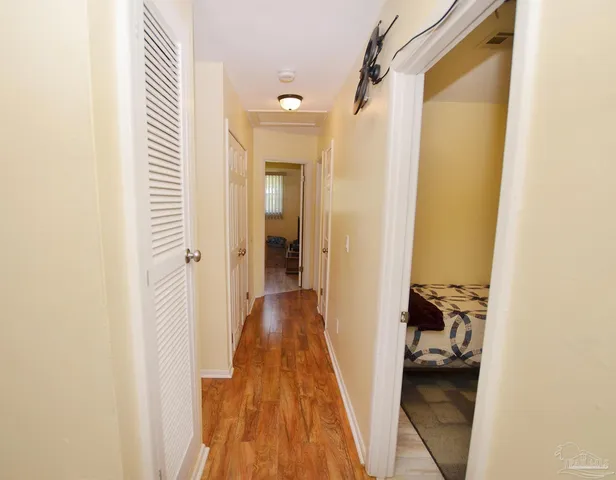 a bathroom with a granite countertop toilet sink and mirror