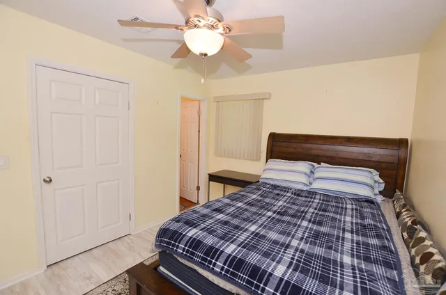 a bedroom with bed and a chandelier