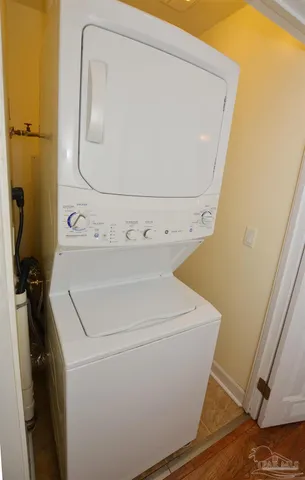 a view of a patio with table and chairs under an umbrella