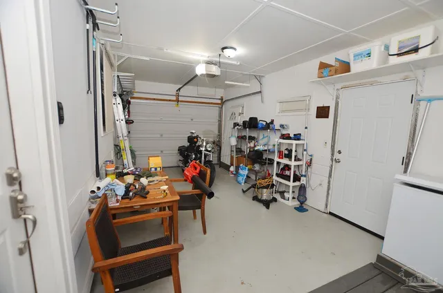 a view of a patio with table and chairs under an umbrella