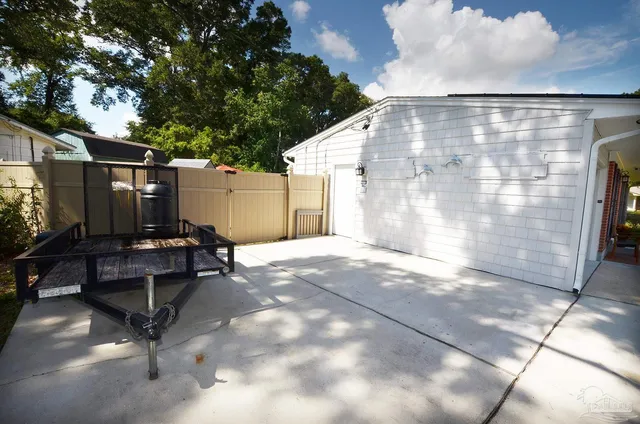 a view of a house with backyard and sitting area