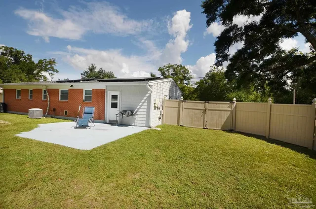 a view of a roof deck with table and chairs a barbeque with wooden floor and fence