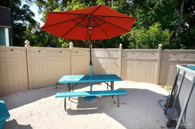 a view of a yard in front of a house with large tree