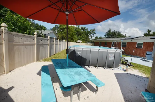 a view of a house with a backyard and deck