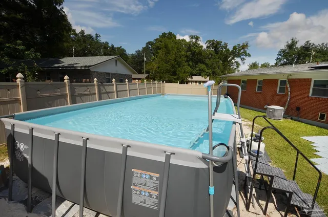 a view of a patio with a table and chairs under an umbrella