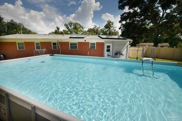 an aerial view of a house with swimming pool
