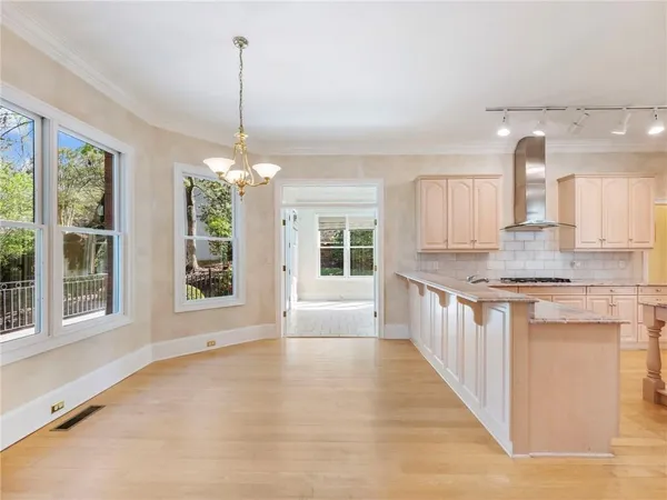 a kitchen with stainless steel appliances granite countertop a sink and refrigerator