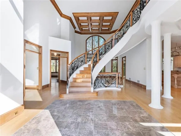 a view of entryway and hall with wooden floor