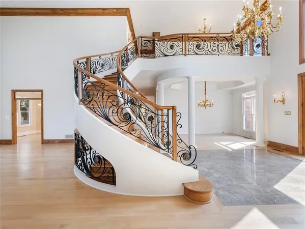 a bedroom with a bed and a chandelier