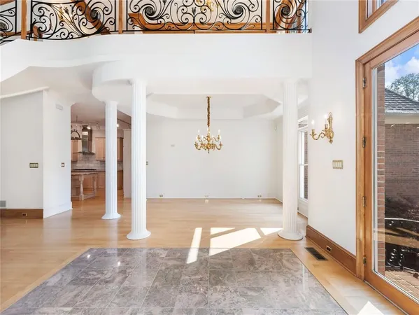 a view of a room with window and hardwood floor