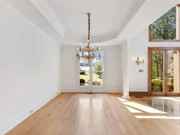 a view of an empty room with window and fire place