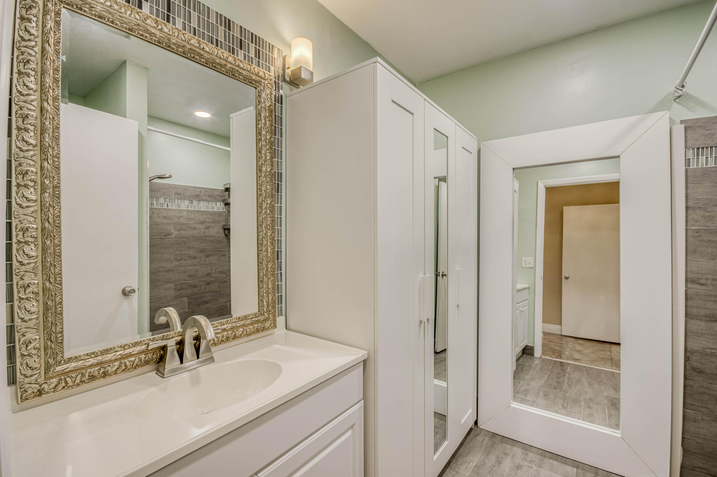 9109 Southwest 21st Street, Unit E Boca Raton, FL 33428 - Photo 13 of 24 a bathroom with a sink and a mirror
