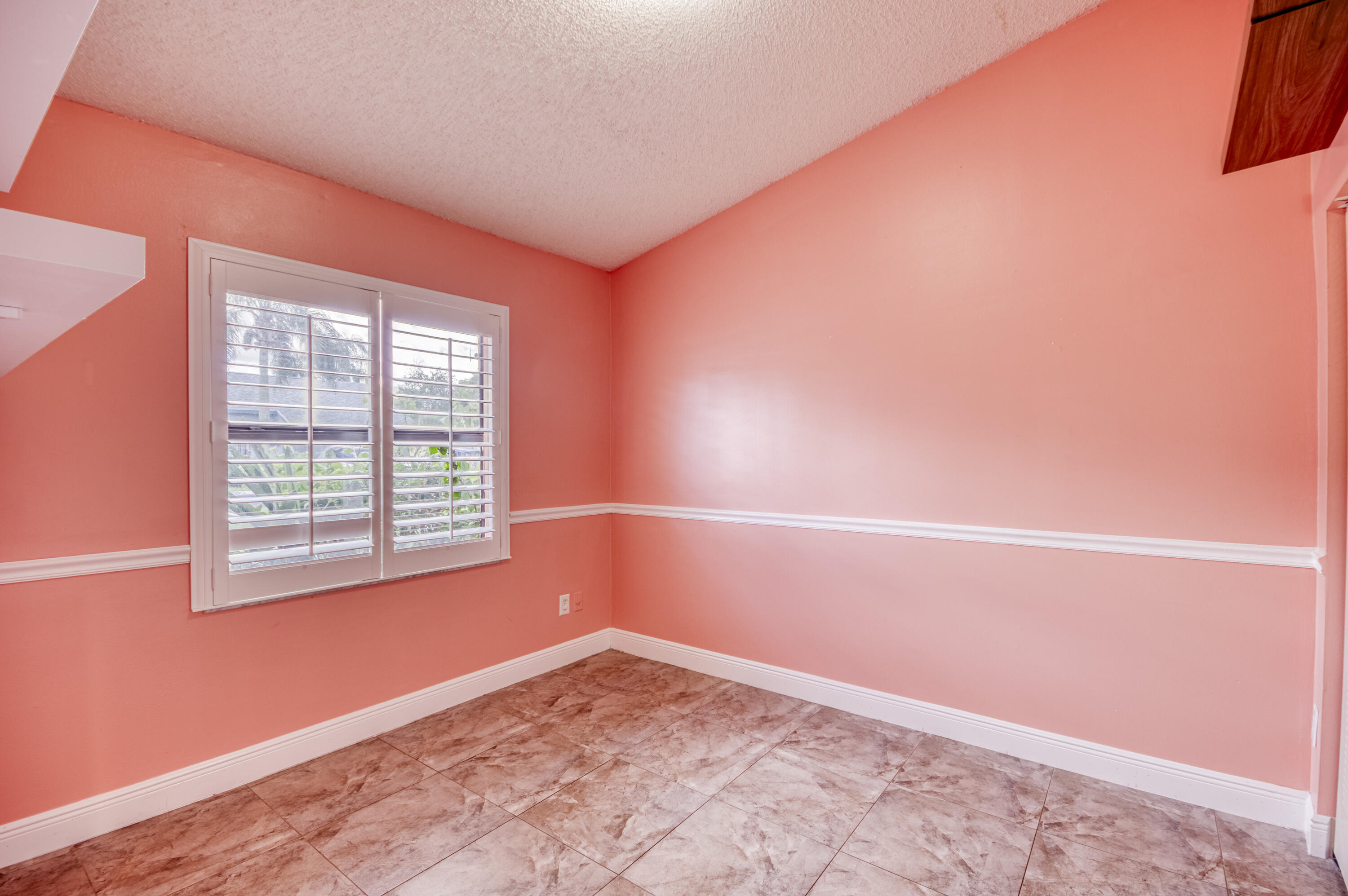 9109 Southwest 21st Street, Unit E Boca Raton, FL 33428 - Photo 16 of 24 a view of an empty room with a window