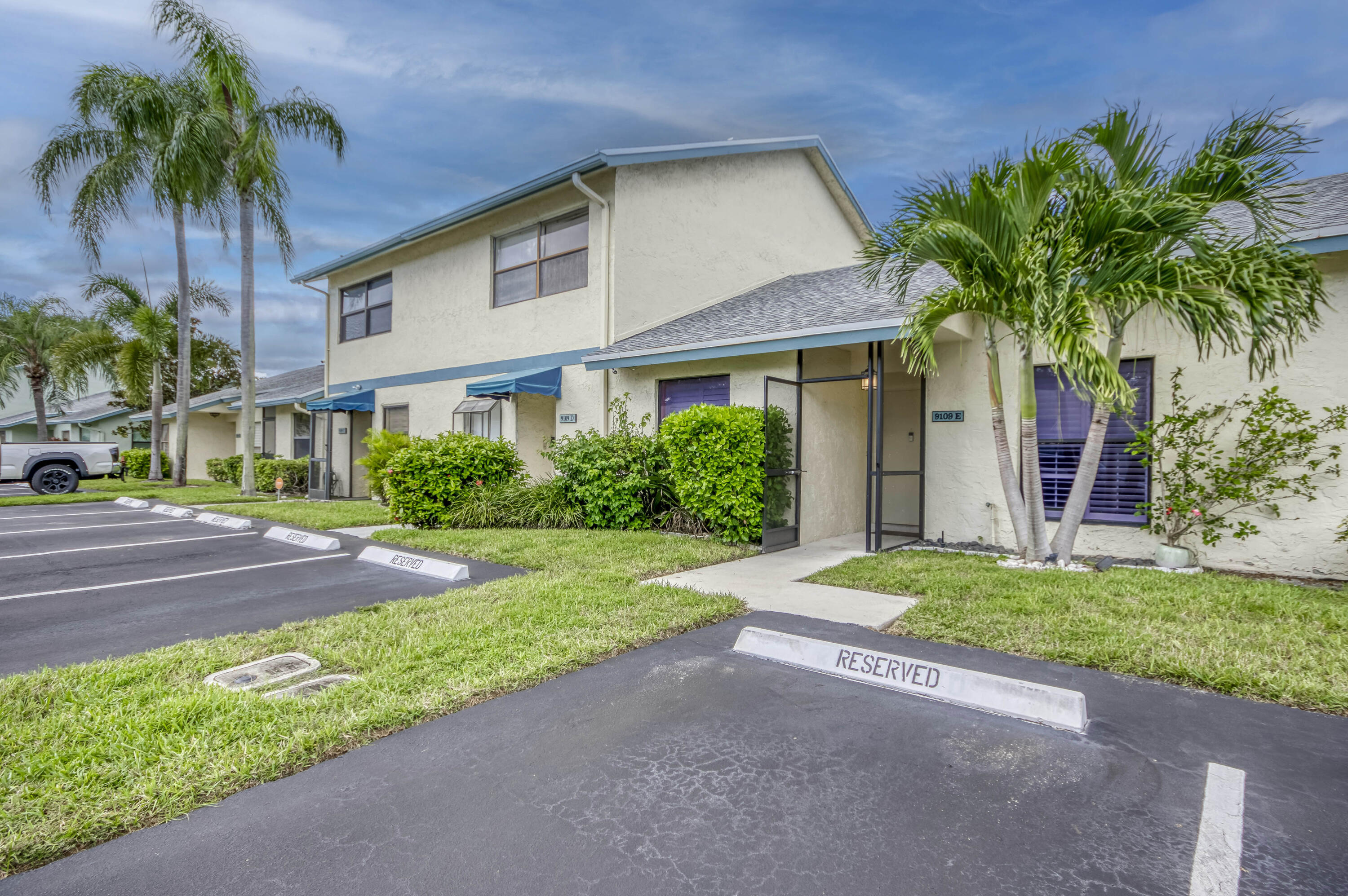 9109 Southwest 21st Street, Unit E Boca Raton, FL 33428 - Photo 2 of 24 a front view of house with yard and green space