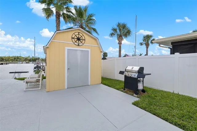 a view of a house with swimming pool and sitting area