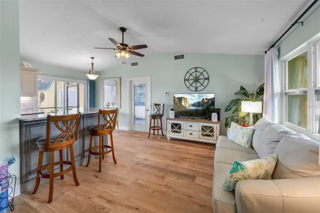 a living room with furniture a rug and a window