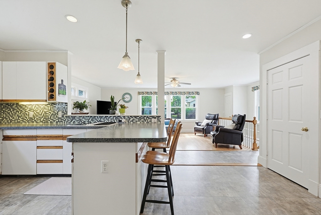24 Riverside Place Walpole, MA 02081 - Photo 11 of 39 a kitchen with counter top space and living room view