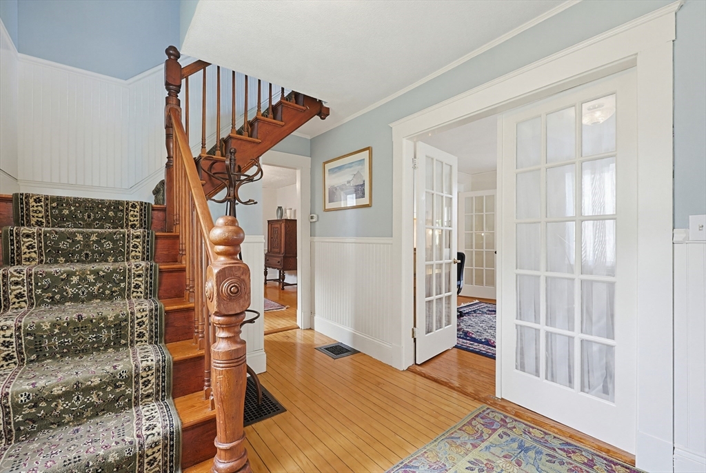 24 Riverside Place Walpole, MA 02081 - Photo 17 of 39 view of hall way with wooden floor and stairs